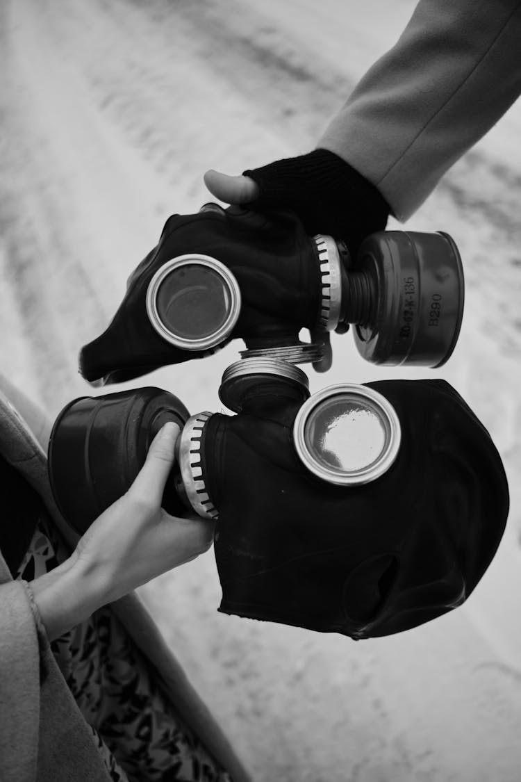 People Holding Gas Masks