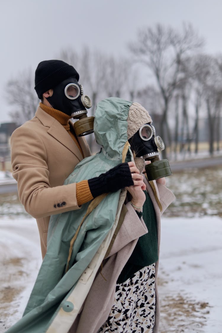 Man And Woman Wearing Gas Masks