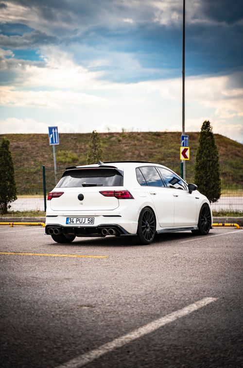 Free Stylish white car captured in an outdoor parking lot, showcasing sleek design. Stock Photo