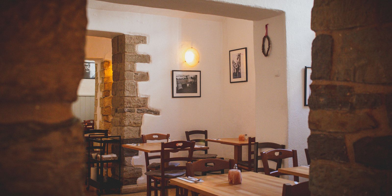 A warm, inviting small-town restaurant interior with rustic wooden furniture