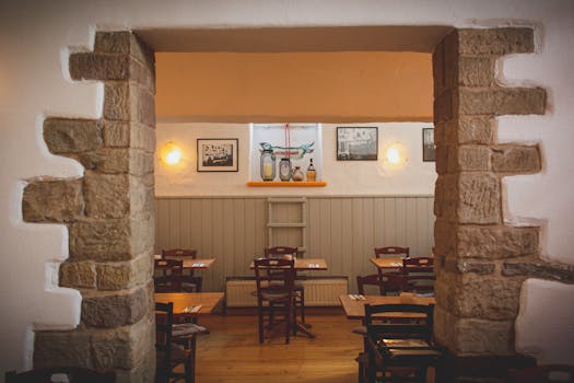 Warm and inviting restaurant interior with rustic stone walls and wooden furniture.