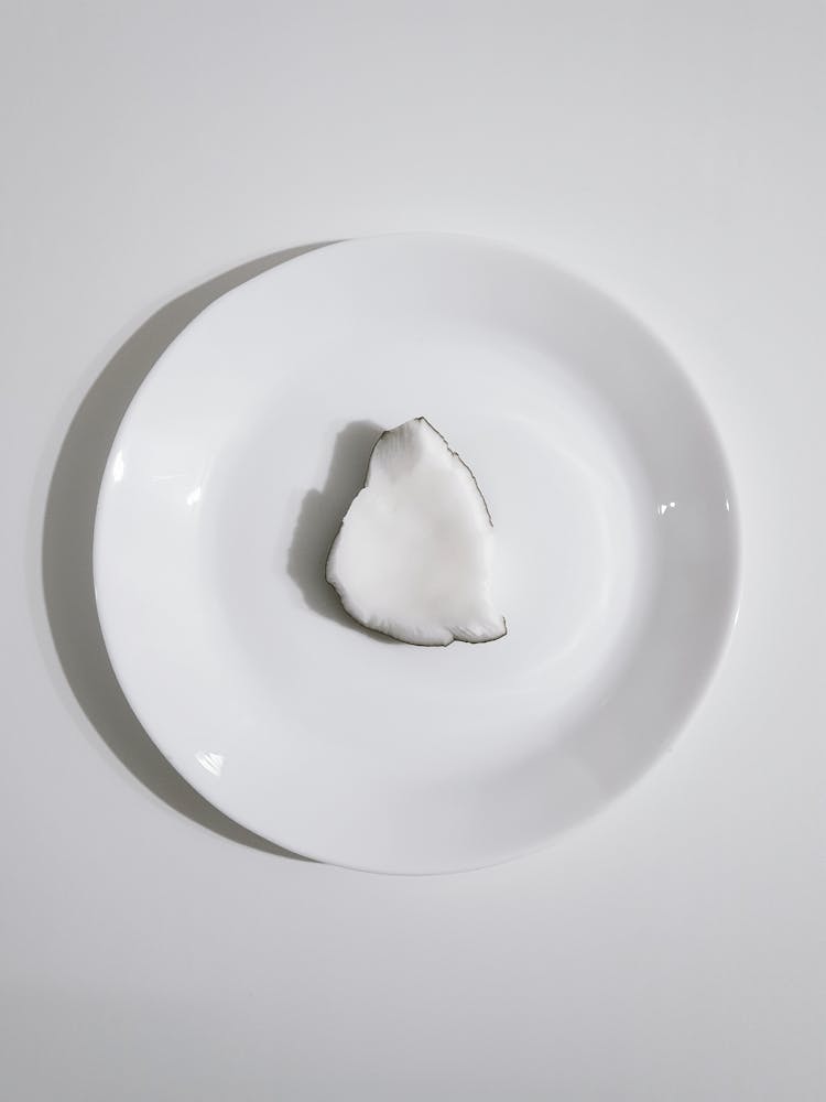 A Piece Of Coconut On A White Plate