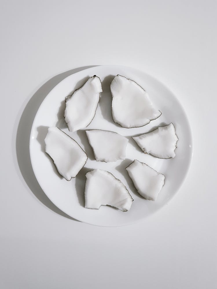 Pieces Of Coconut On A White Plate 