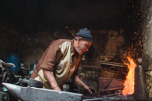 Man Doing Metalwork in a Workshop 