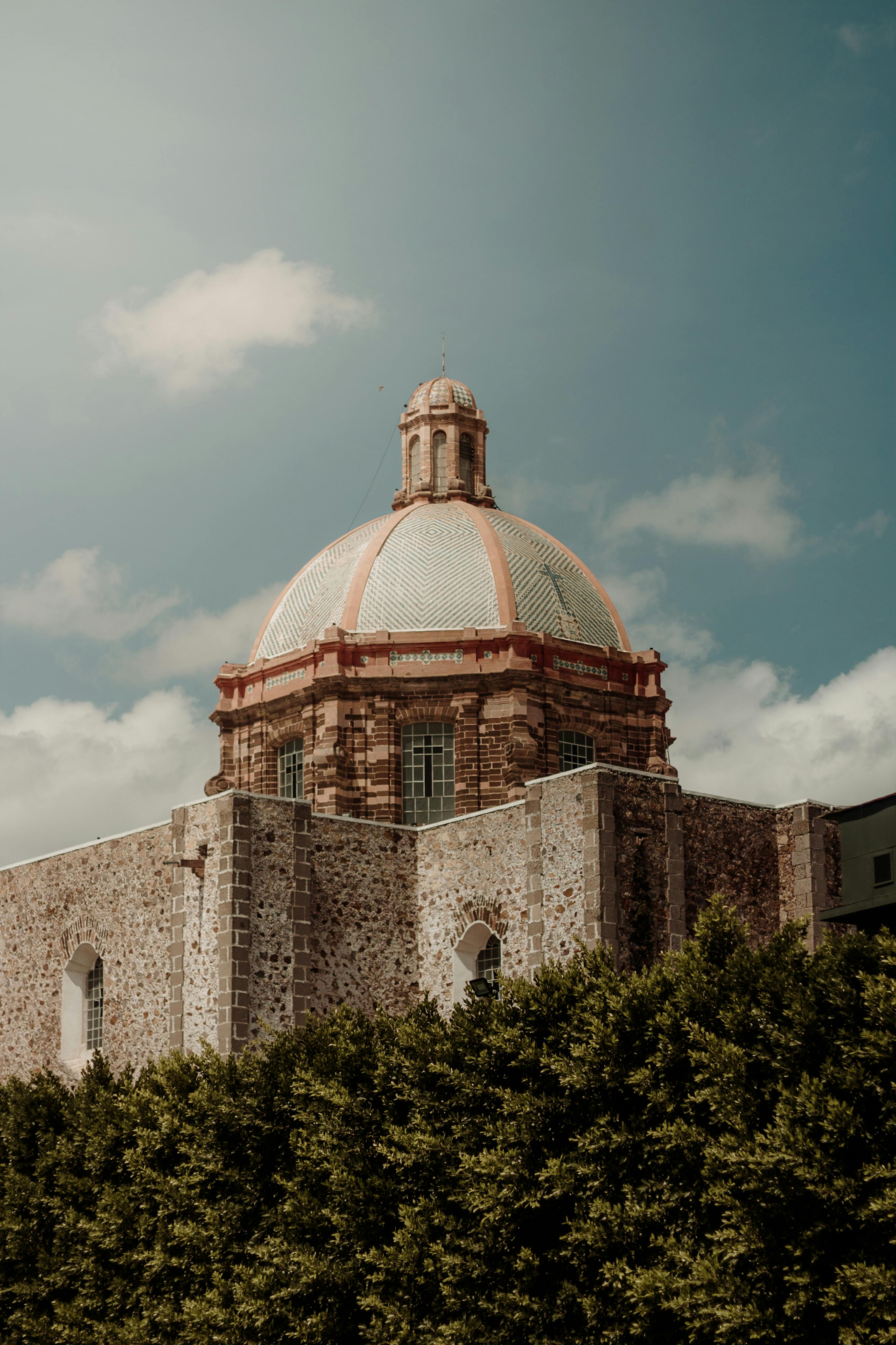 Majestic dome of a historic church in San Miguel de Allende, Mexico, under a clear sky.