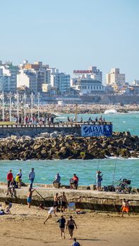 Vibrant beach activity with city skyline in Mar del Plata, Argentina. Perfect summer getaway.