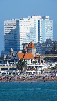 Vibrant beach and modern skyscrapers in Mar del Plata on a sunny summer day.