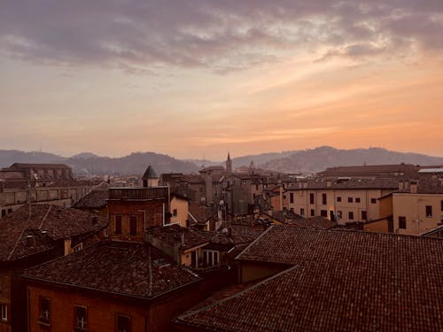 Free The sun sets over the rooftops of a city Stock Photo