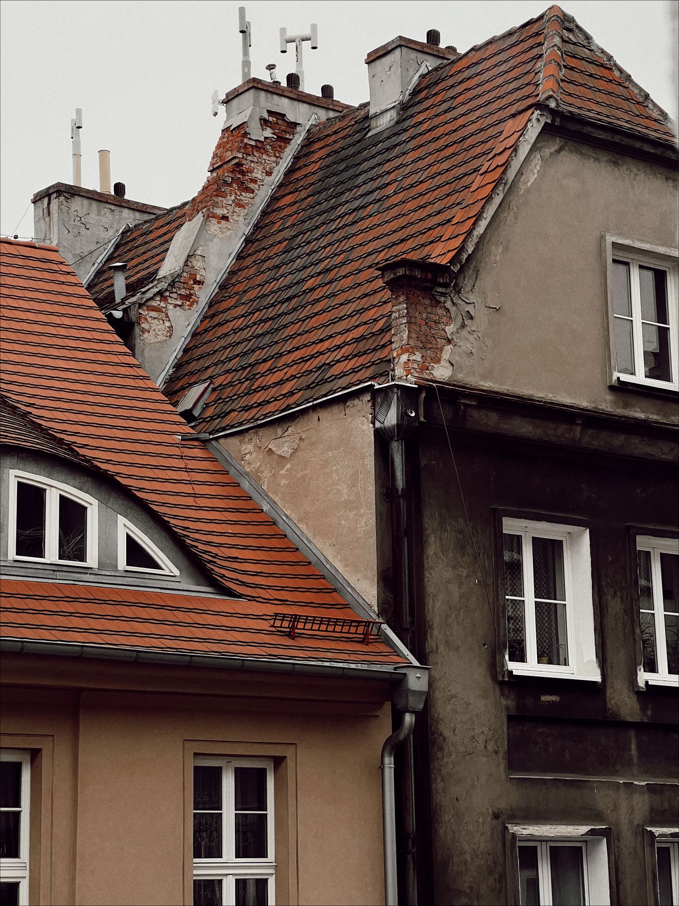 Two houses with clay tiled roofs and dormer windows