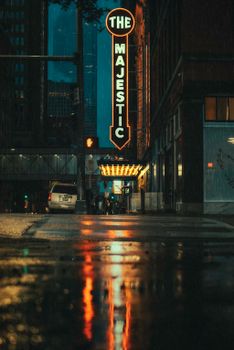 Street view of the illuminated Majestic Theater in downtown Dallas, TX, at night.