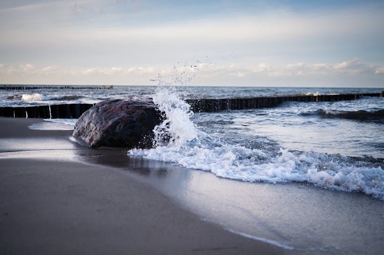 Photo Of A Sea Wave Crashing On A Rock