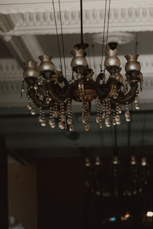 Free A luxurious antique chandelier hanging in an ornate vintage setting indoors. Stock Photo