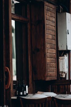 A nostalgic dining room with vintage wooden walls and classic tableware, creating a cozy atmosphere.