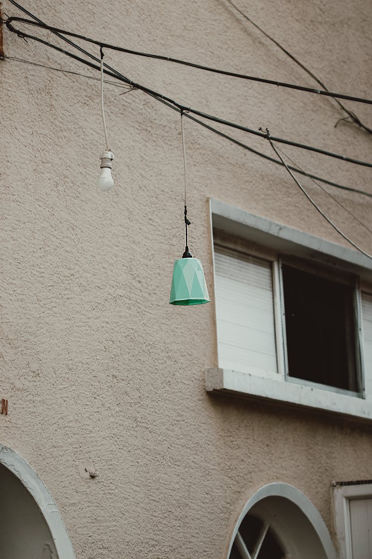 Light Bulb And A Light Fixture Hanging Outdoors