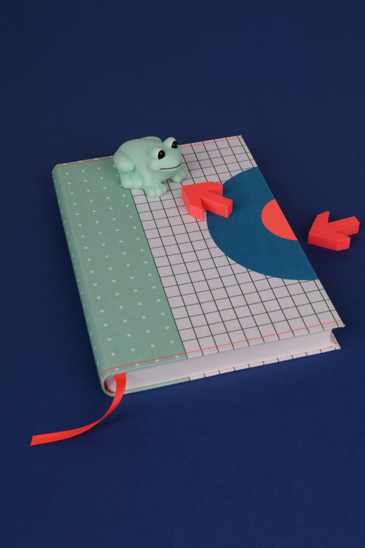 Arrows And Toy On Notebook