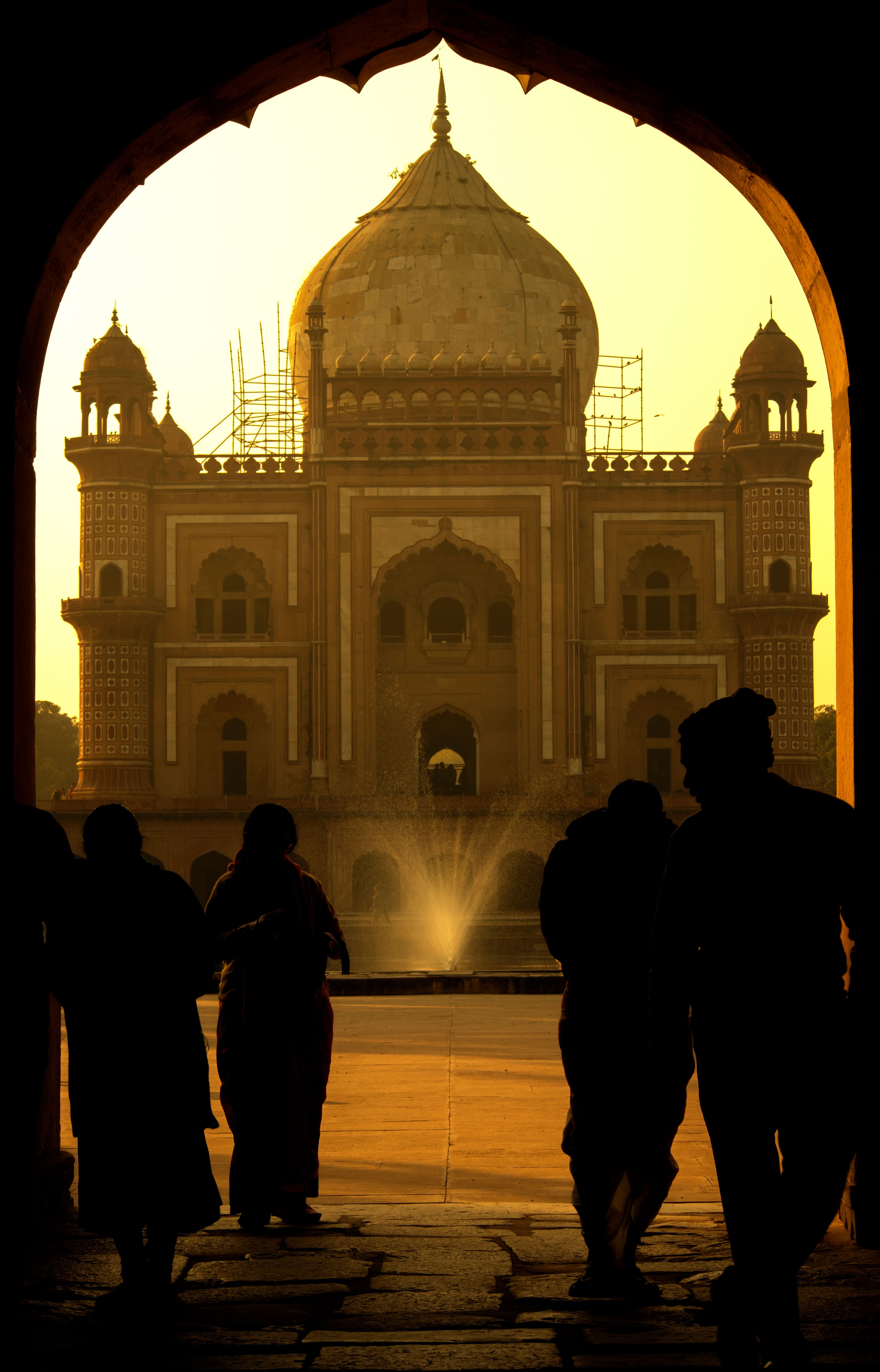 A captivating silhouette of people at Safdarjung Tomb, New Delhi, during sunset.