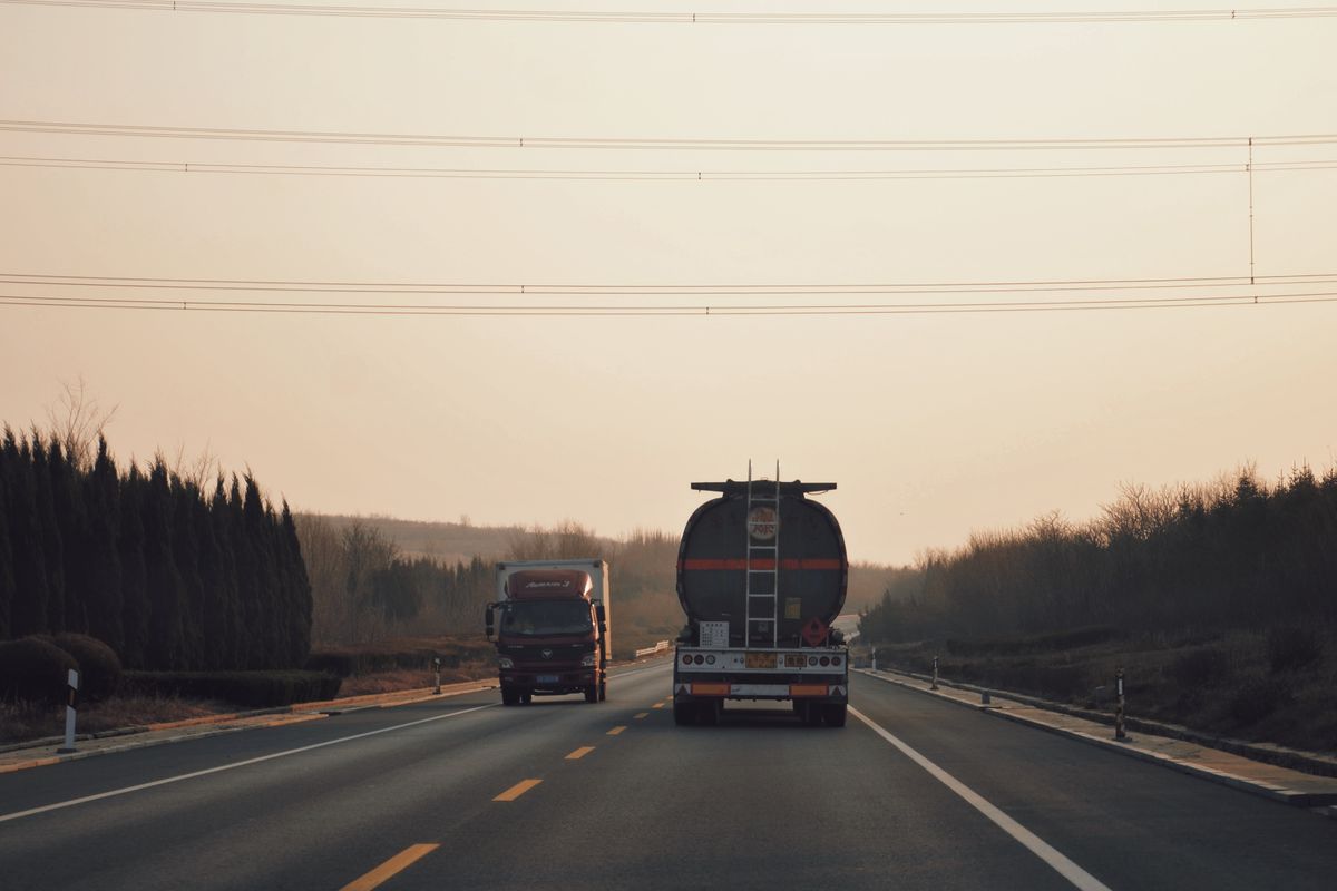 Heavy-duty diesel trucks on the highway running on Bodi API CK-4 15W-40 diesel engine oil