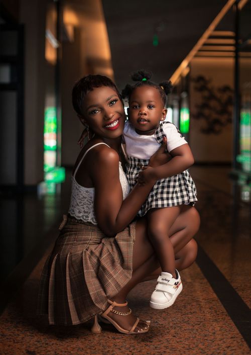 Free Warm and joyful portrait of a mother holding her toddler daughter indoors. Stock Photo