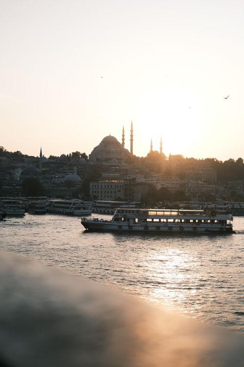 Free Serene view of İstanbul's Golden Horn featuring boats, Hagia Sophia and a captivating sunset. Stock Photo