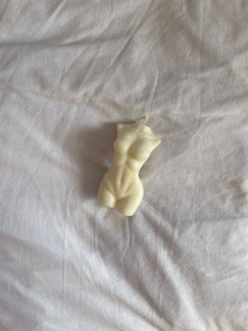 Figure of Human Body on White Sheet