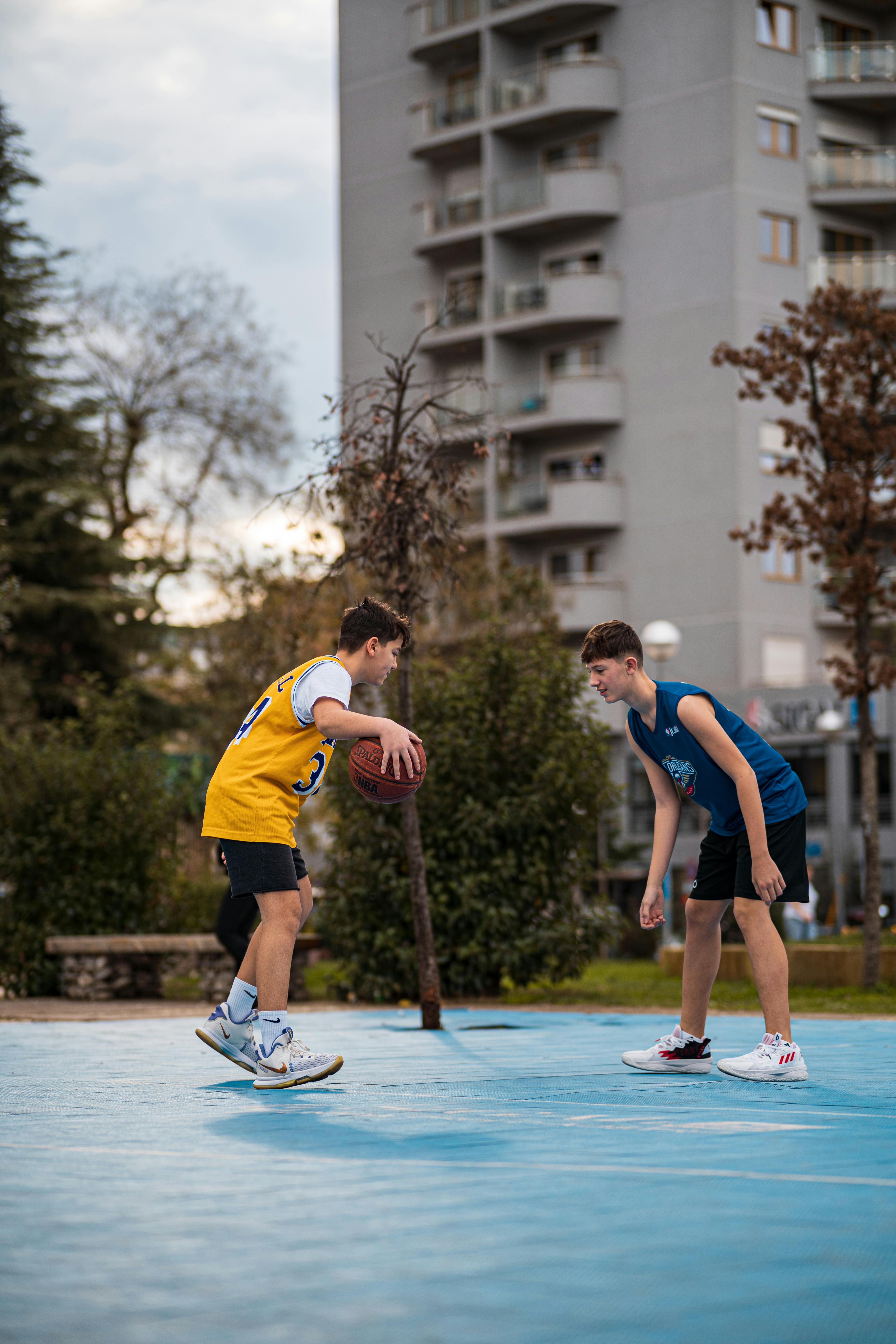 teenagers playing basketball