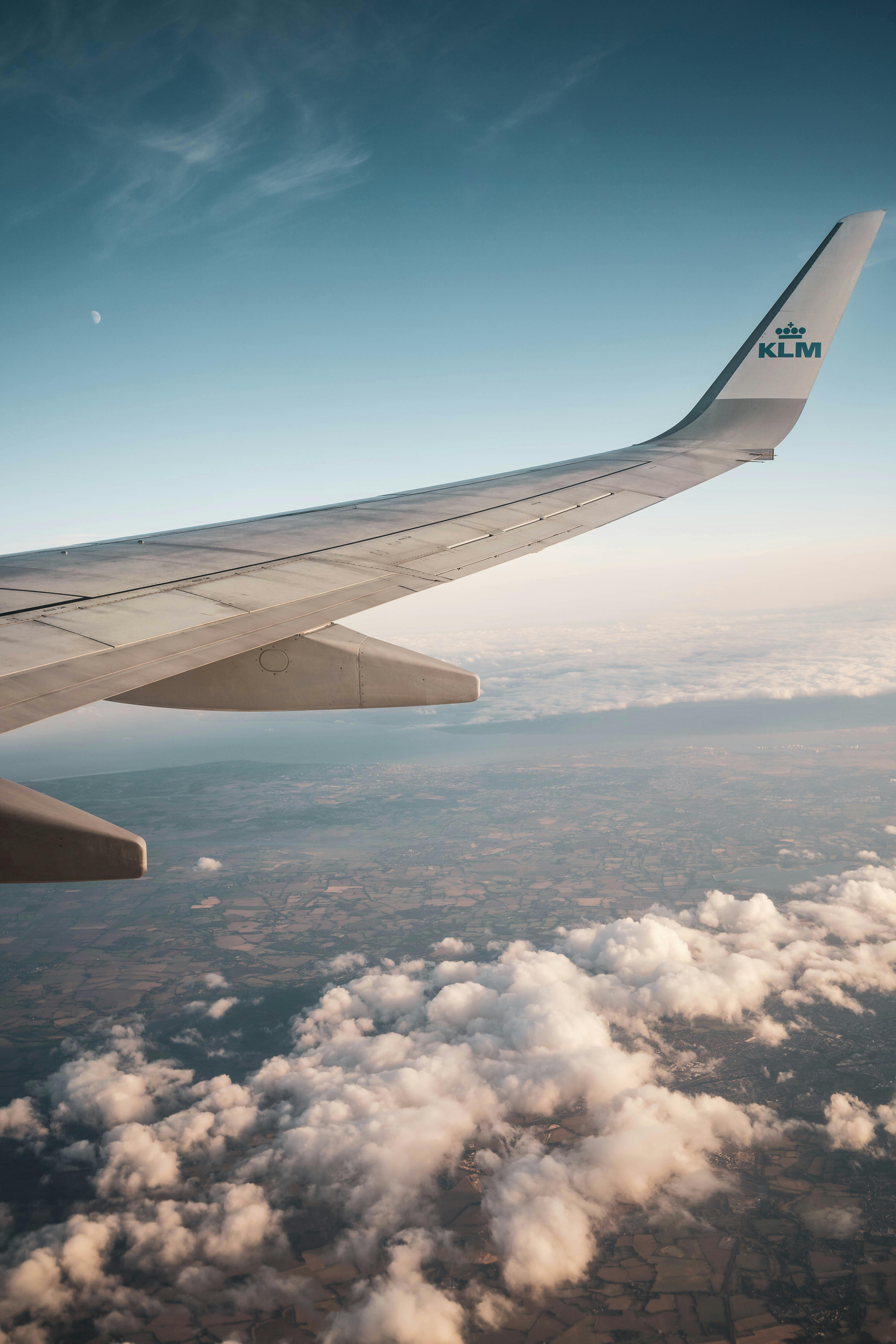 flying klm airliner above clouds