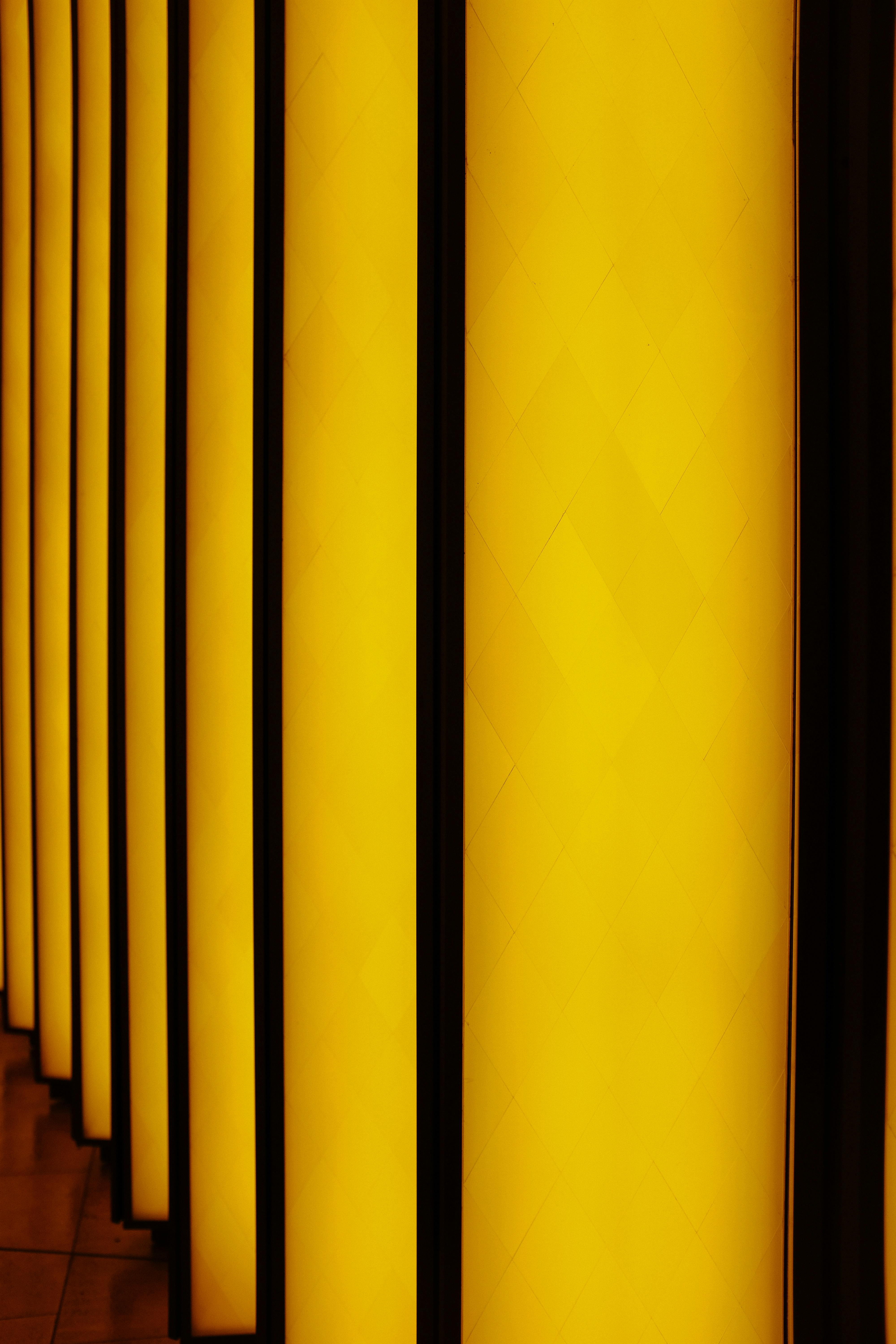 Vibrant abstract image of vertical panels with a striking golden glow, ideal for modern design applications.