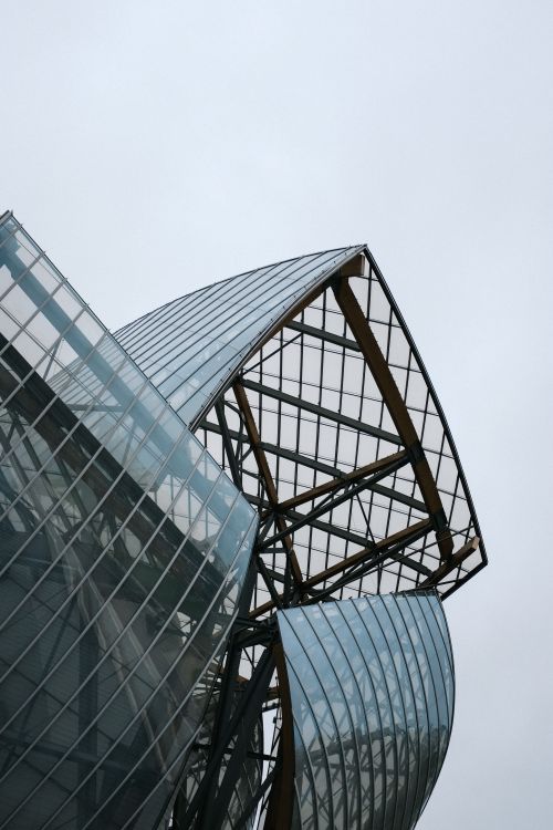 Free Close-up of modern architecture featuring unique glass panel design against the sky. Stock Photo