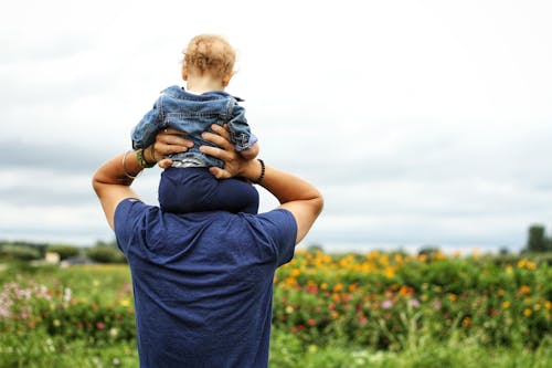 Baby Sitting on Man's Shoulder