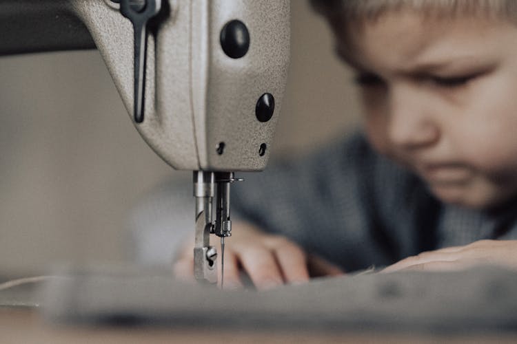 Boy Working On Sewing Machine