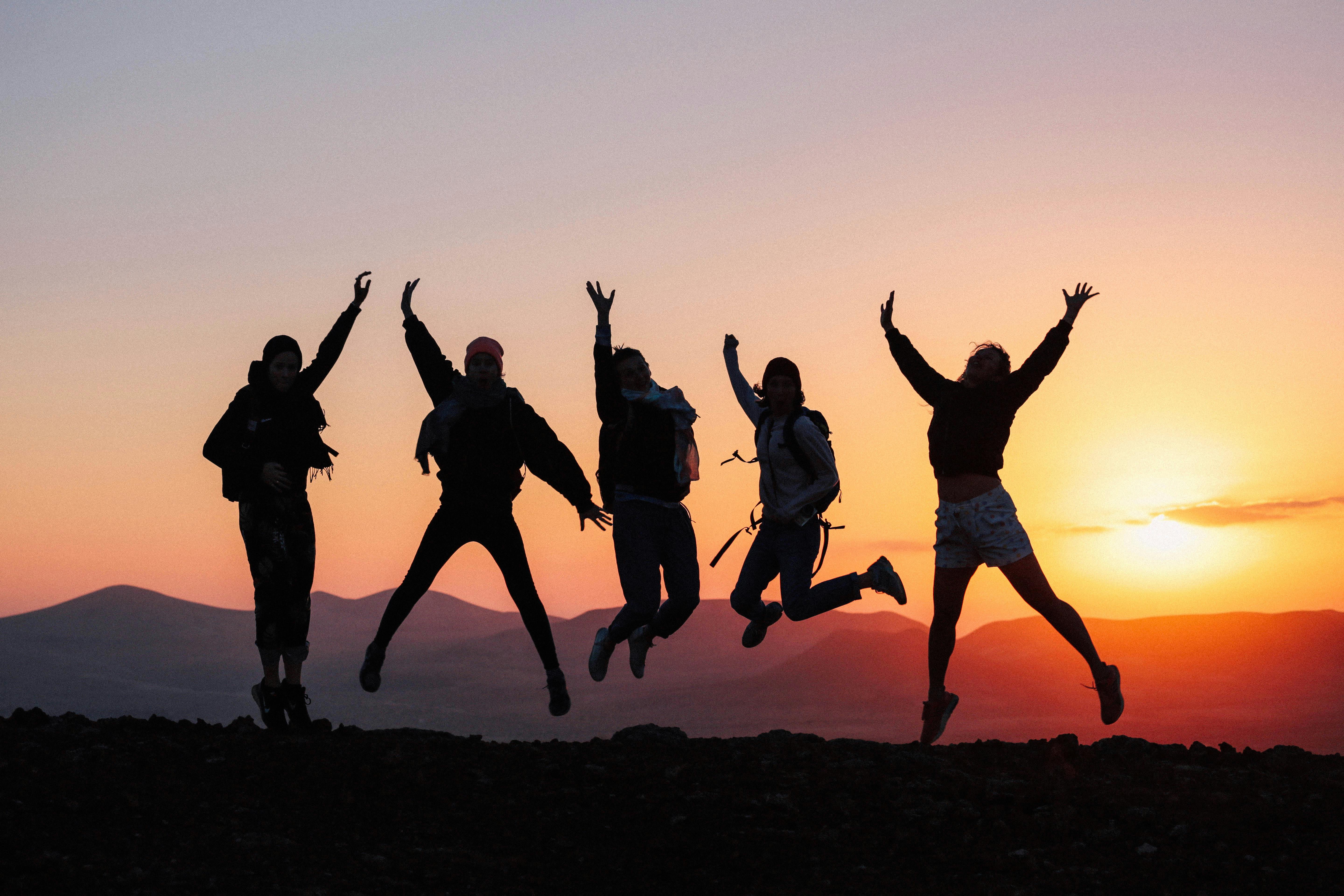 silhouette of group of friends during sunset