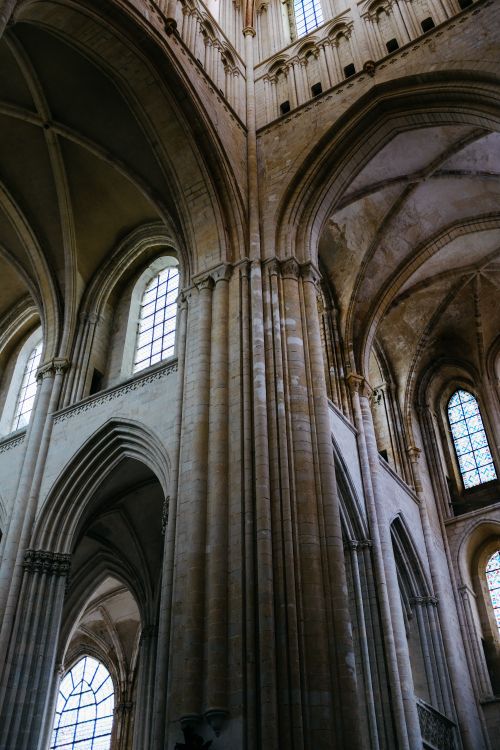 Free Stunning gothic architecture showcasing soaring arches and stone details inside a historic cathedral. Stock Photo