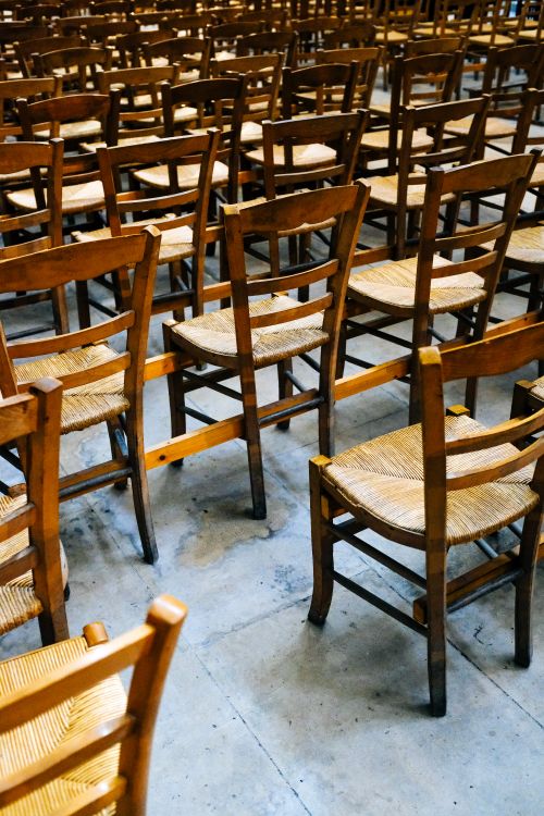 Free High angle view of wooden chairs arranged in rows, creating symmetry. Stock Photo