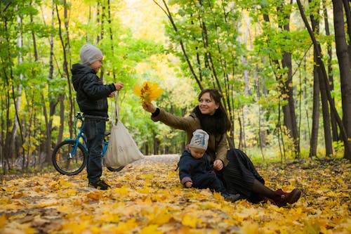 Woman And Children Playing With Leaves