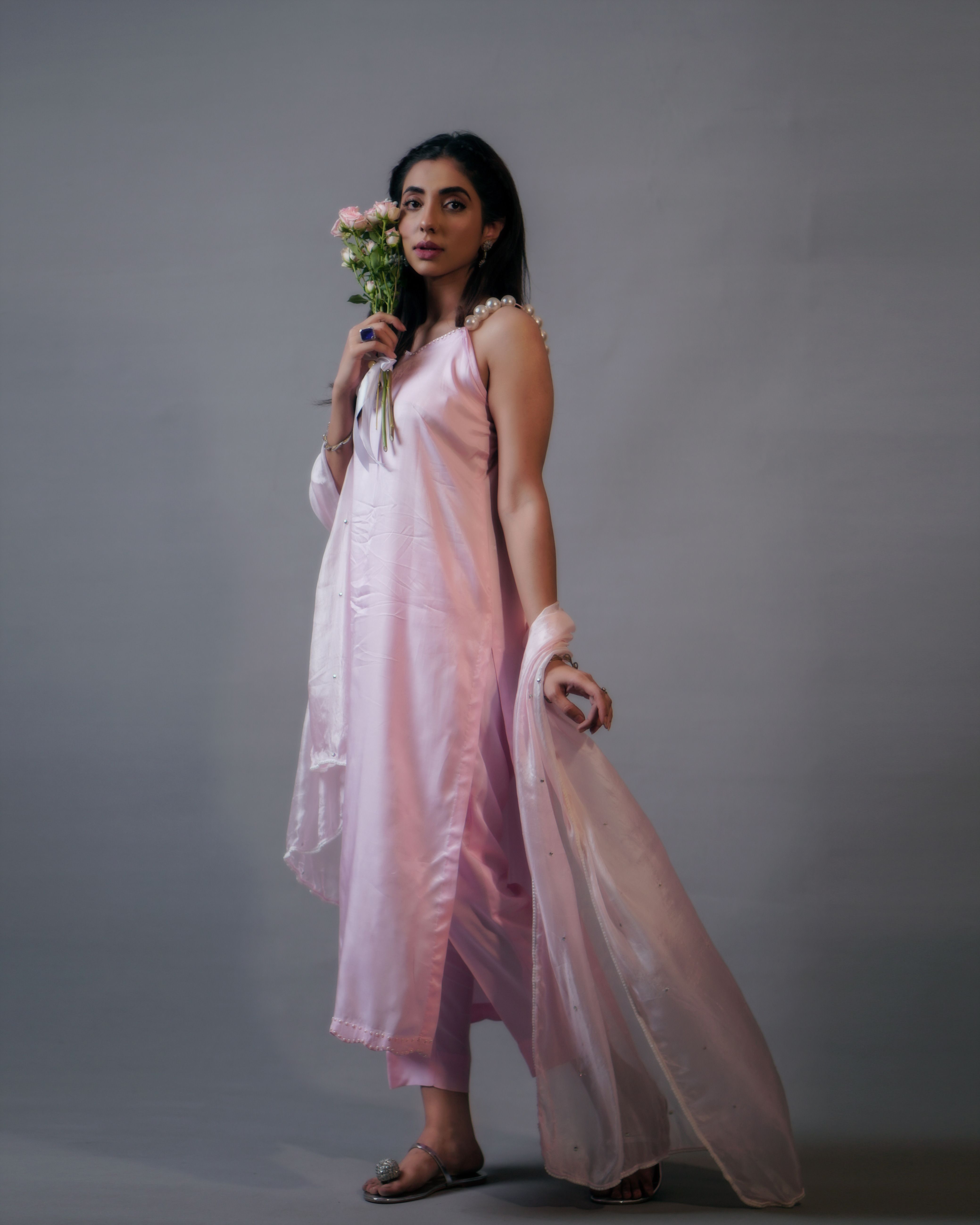 Woman in a Pink Dress Holding Flowers · Free Stock Photo