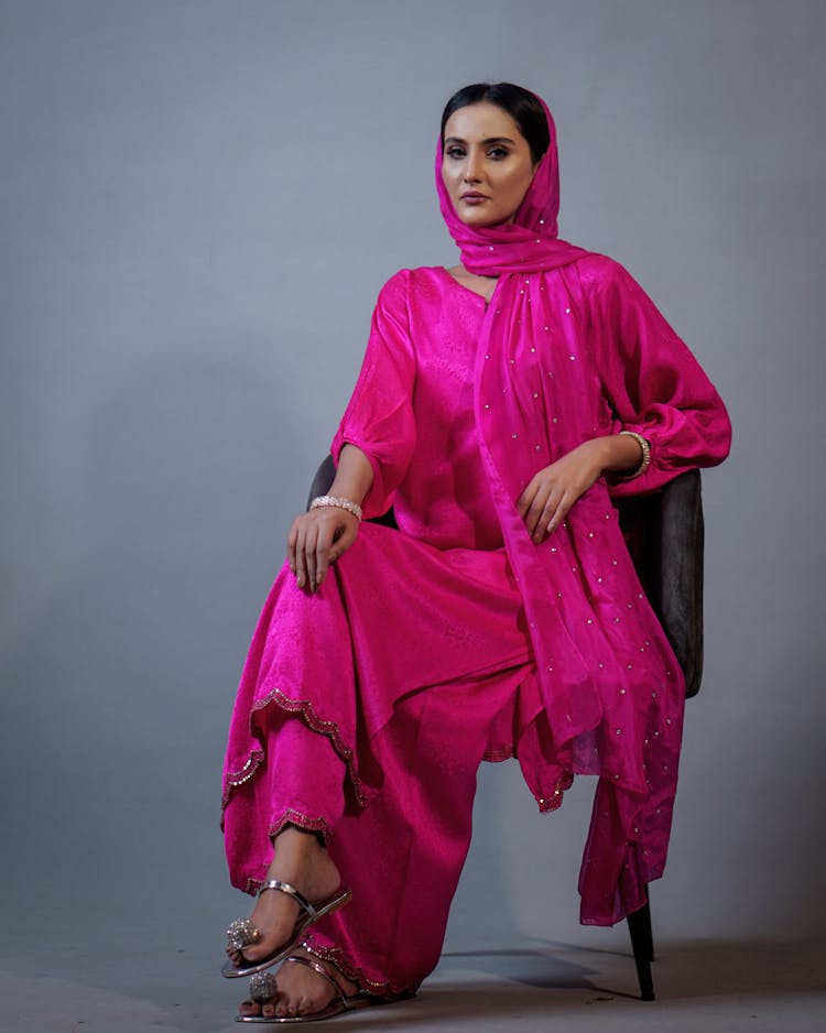 A Woman In Pink Long Sleeve Dress