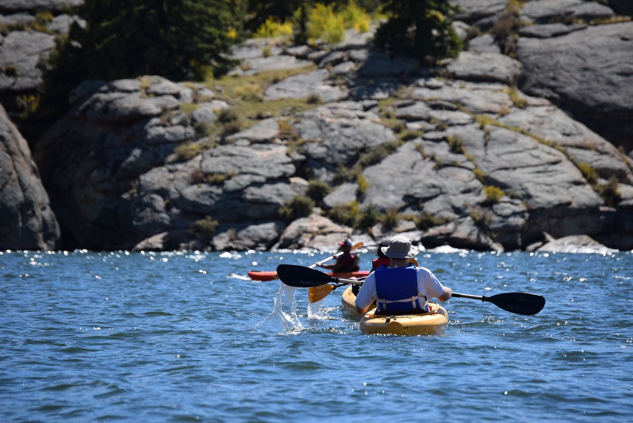 Kayaking on a calm river surrounded by pine forests in Oregon