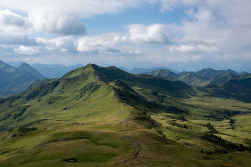 Free Explore a stunning mountain landscape with verdant valleys, ideal for hiking during summer. Stock Photo