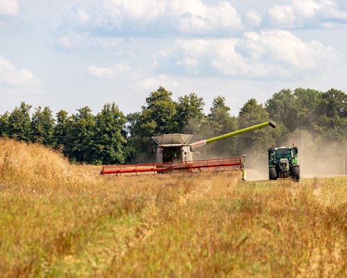 Combine Harvester and Tractor on Field