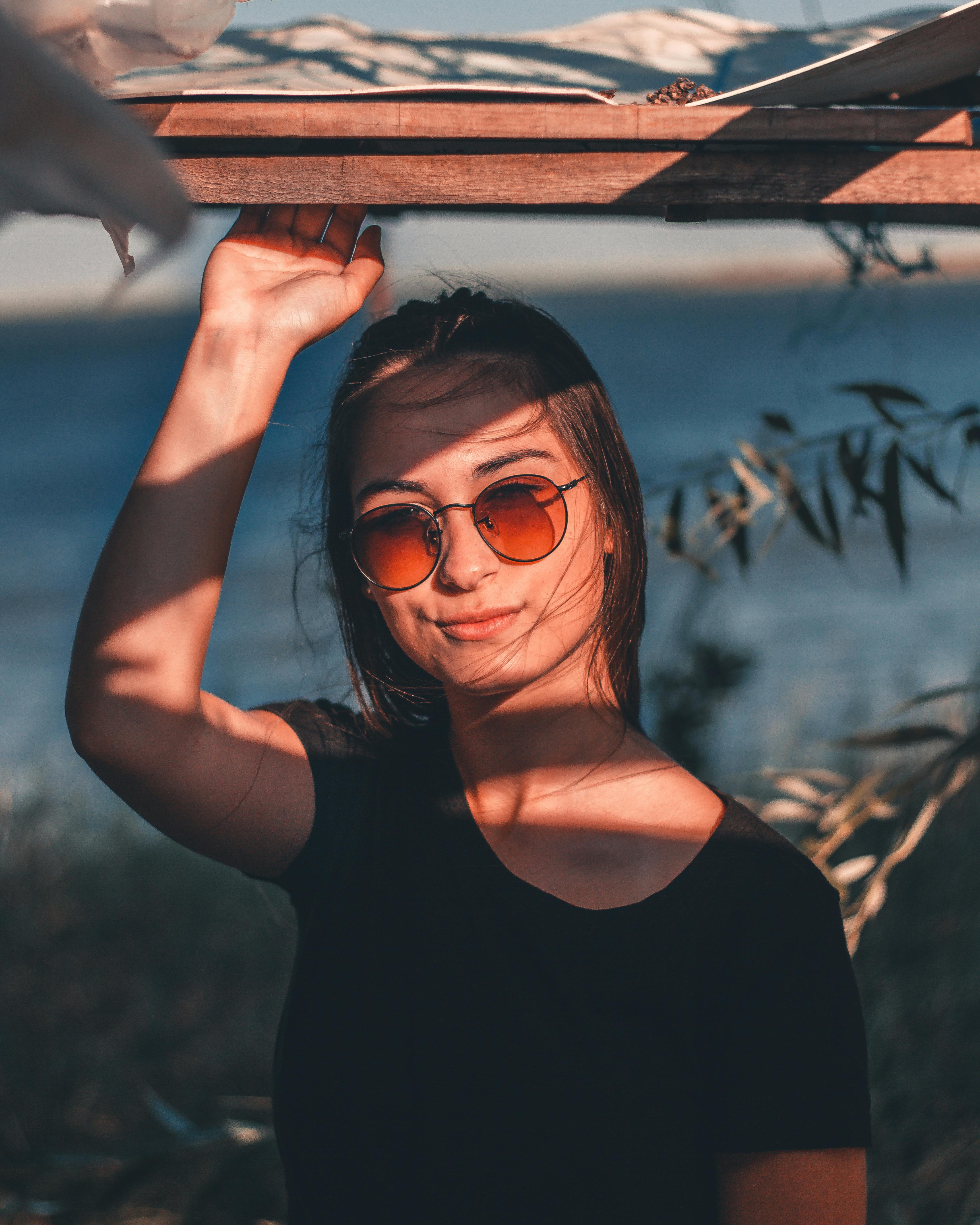 Woman Standing Against Flowers · Free Stock Photo