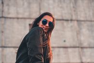 Woman in Black Jacket Wearing Sunglasses