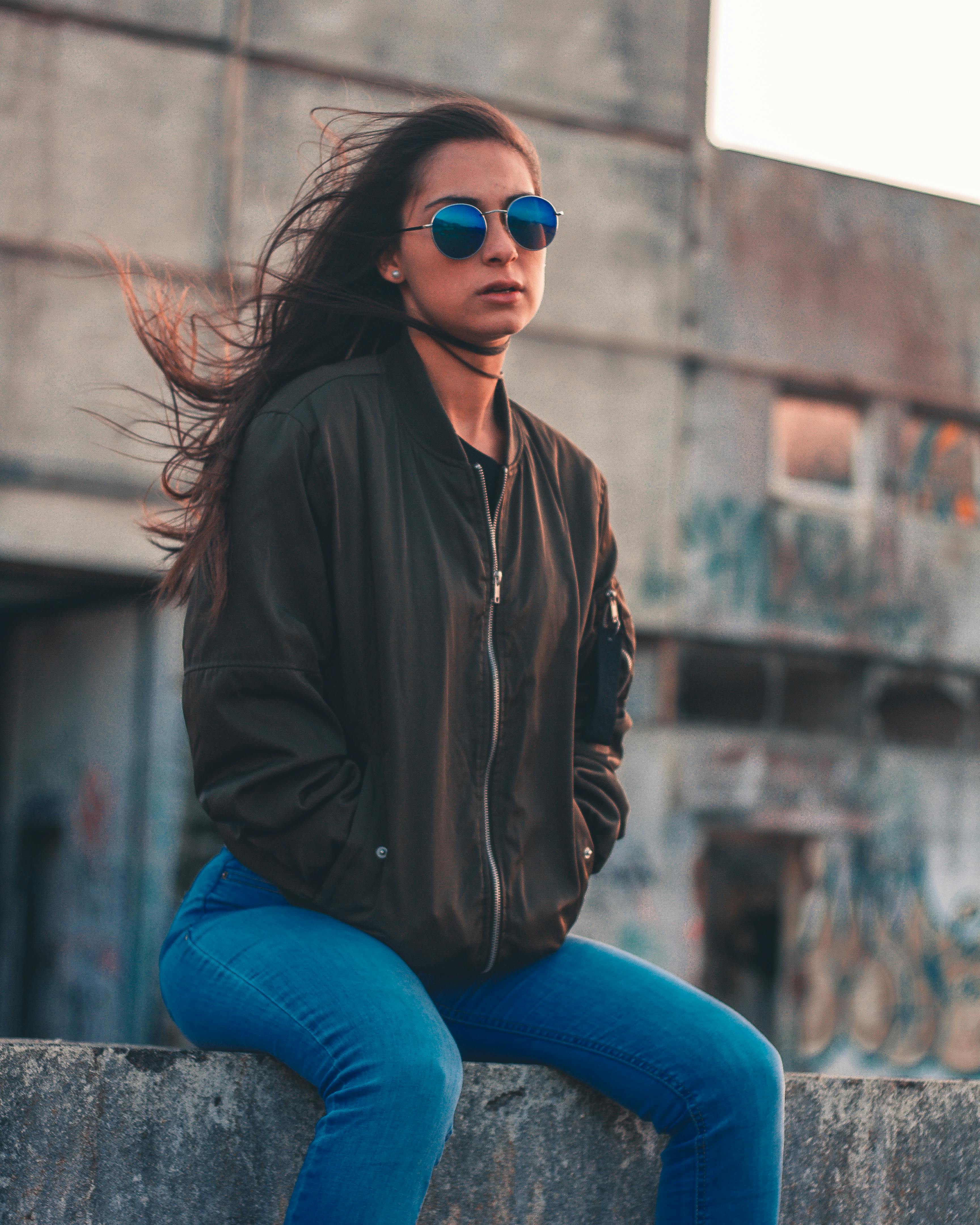 photo of a woman sitting on ledge