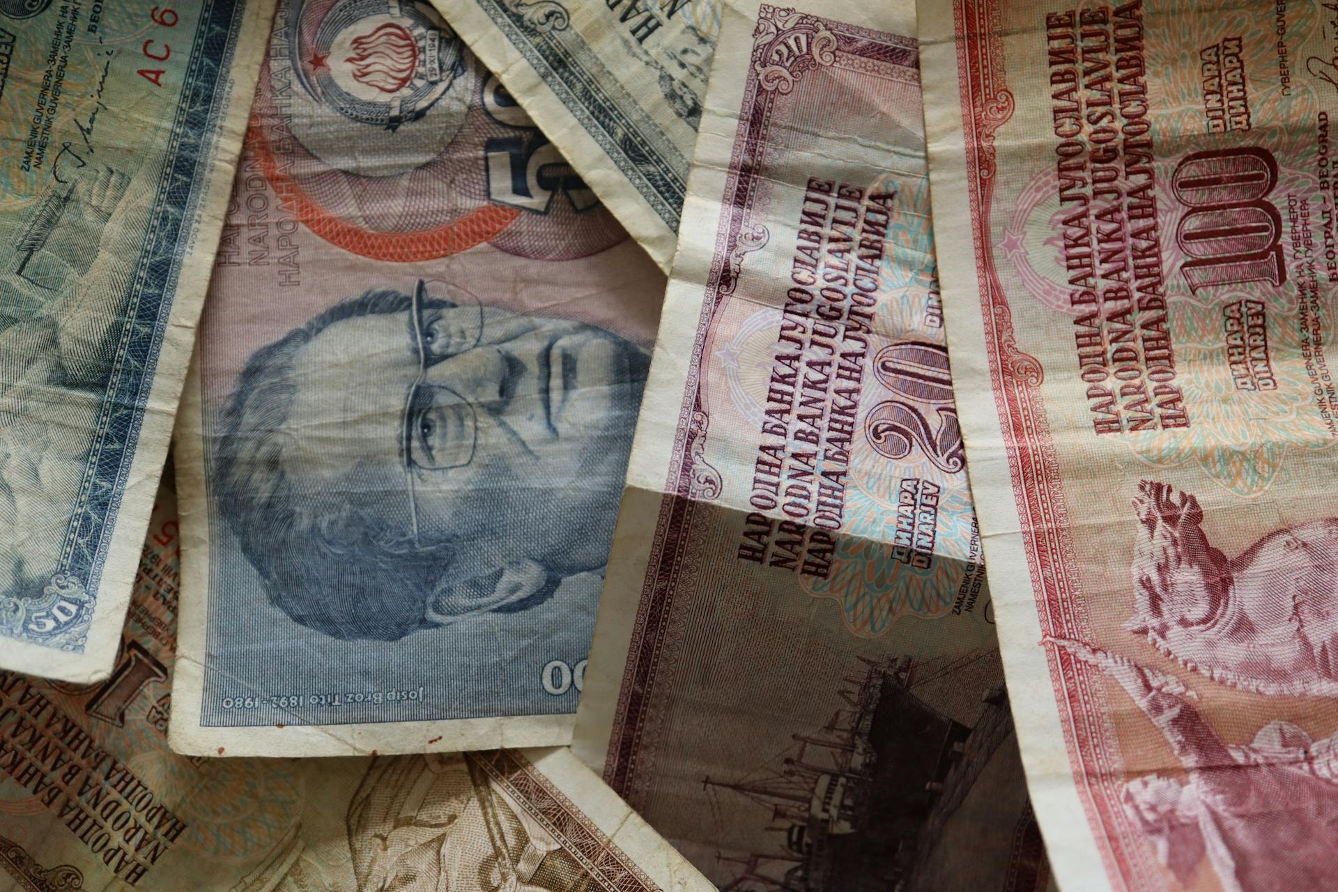 A close-up photo of diverse vintage banknotes, showcasing historical currency from different countries.