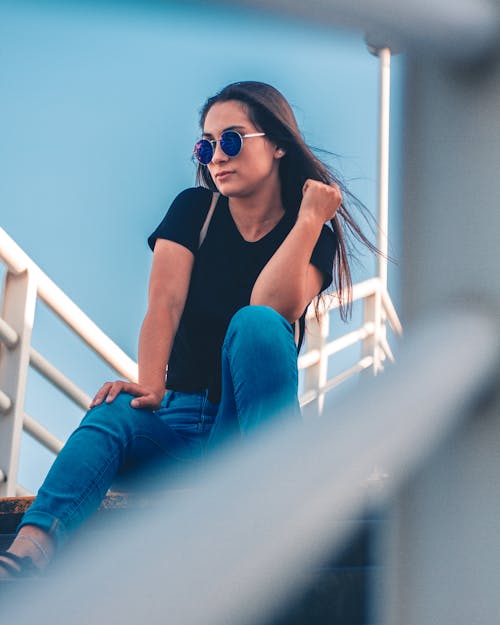 Free Woman Sitting On Stairs Posing For Photo Stock Photo