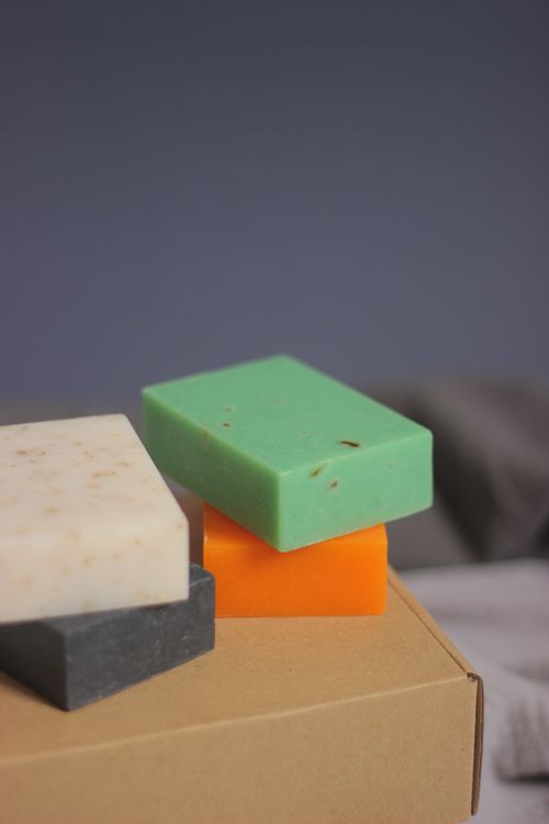 Free Close-up of colorful soap bars stacked on a cardboard box, showcasing natural skincare. Stock Photo