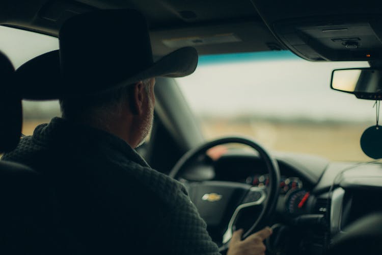 Man In Hat Driving