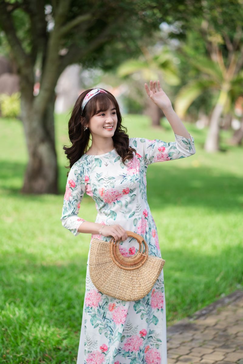 woman in a floral midi dress smiling outdoors