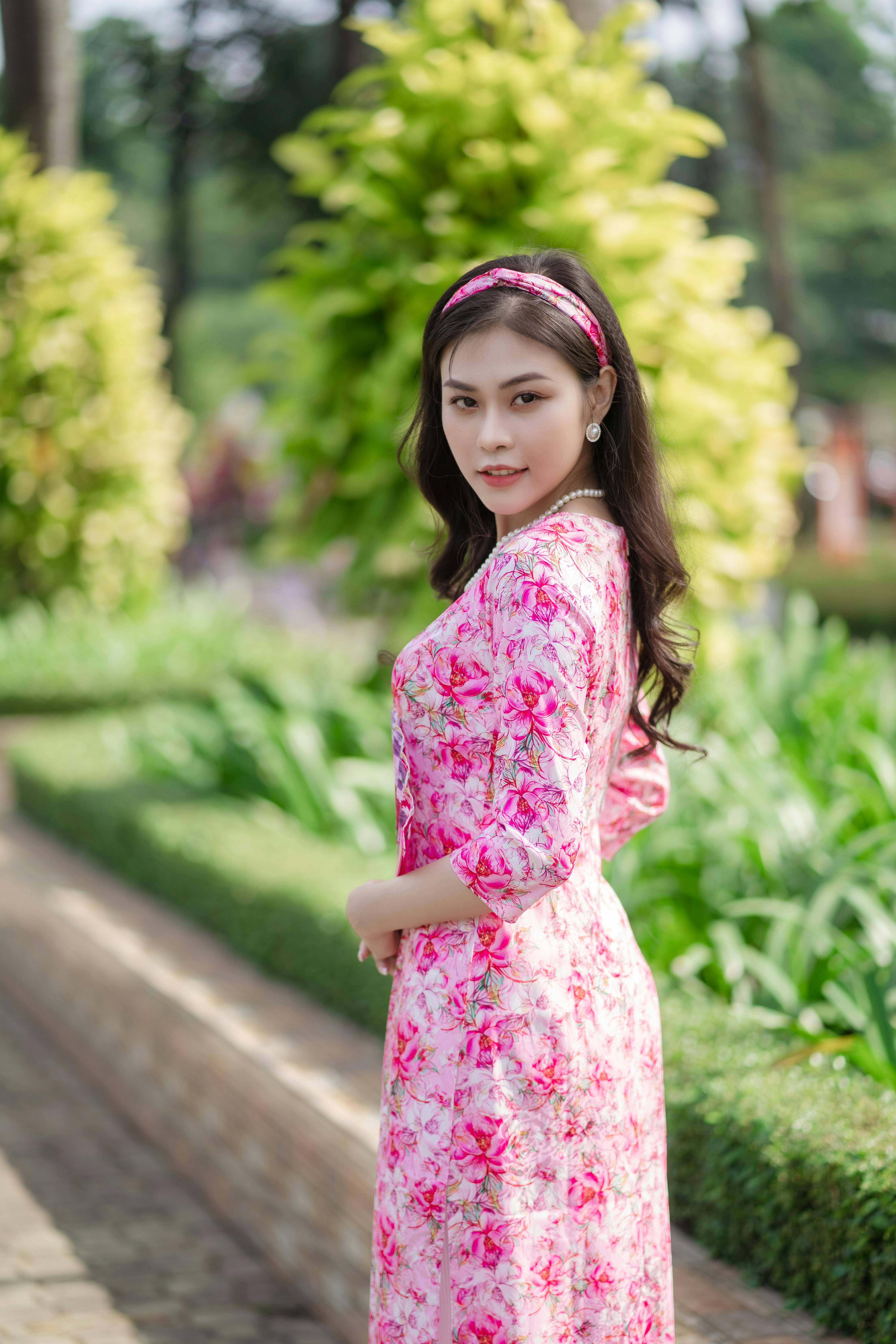 A Woman in Red Tube Dress and Floral Shawl Free Stock Photo