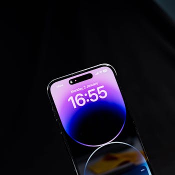 Sleek modern smartphone displaying time against a black background in vertical orientation.
