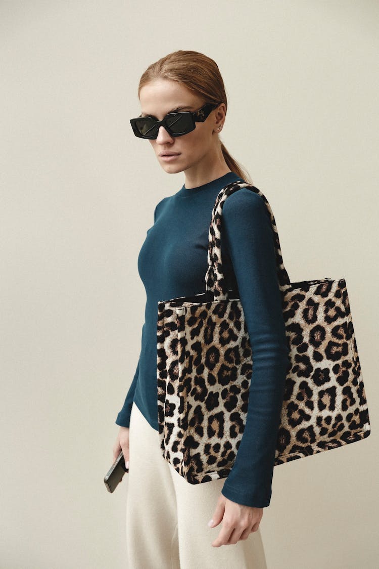 Woman In Sunglasses Posing In Studio